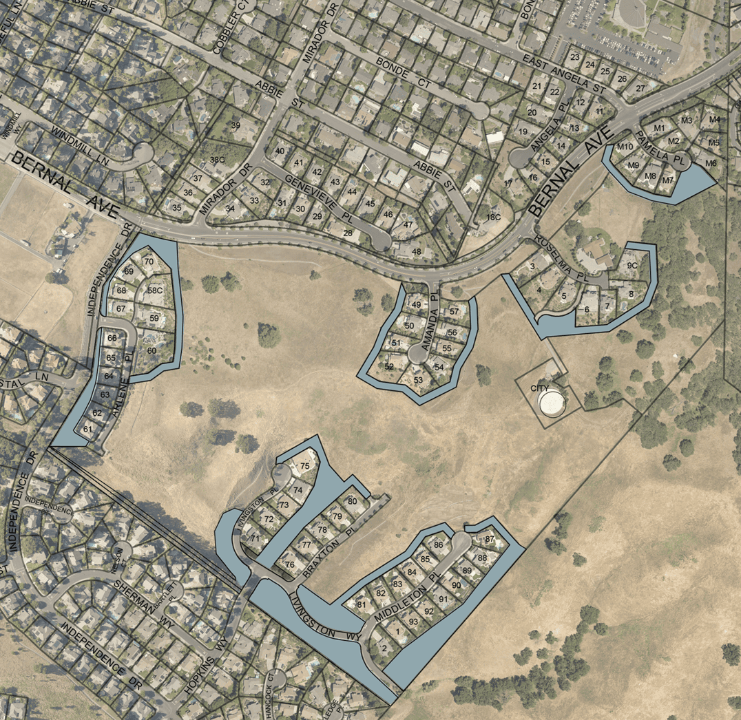 Aerial View Map Showing Undeveloped Land Surrounded By Residential Neighborhoods. Lot Outlines And Street Names Are Visible. Several Cul-De-Sacs Are Marked, With Open Grassy Areas And Patches Of Trees Interspersed.